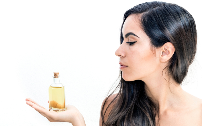 woman with argan oil bottle